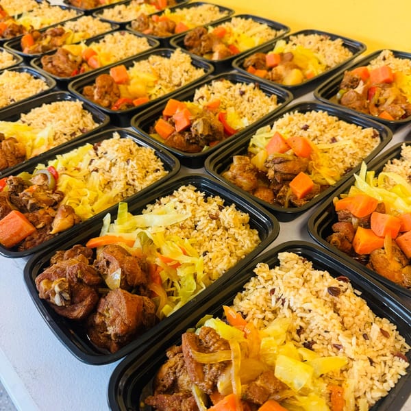 Rows of takeout containers filled with rice, stewed chicken, and cabbage.
